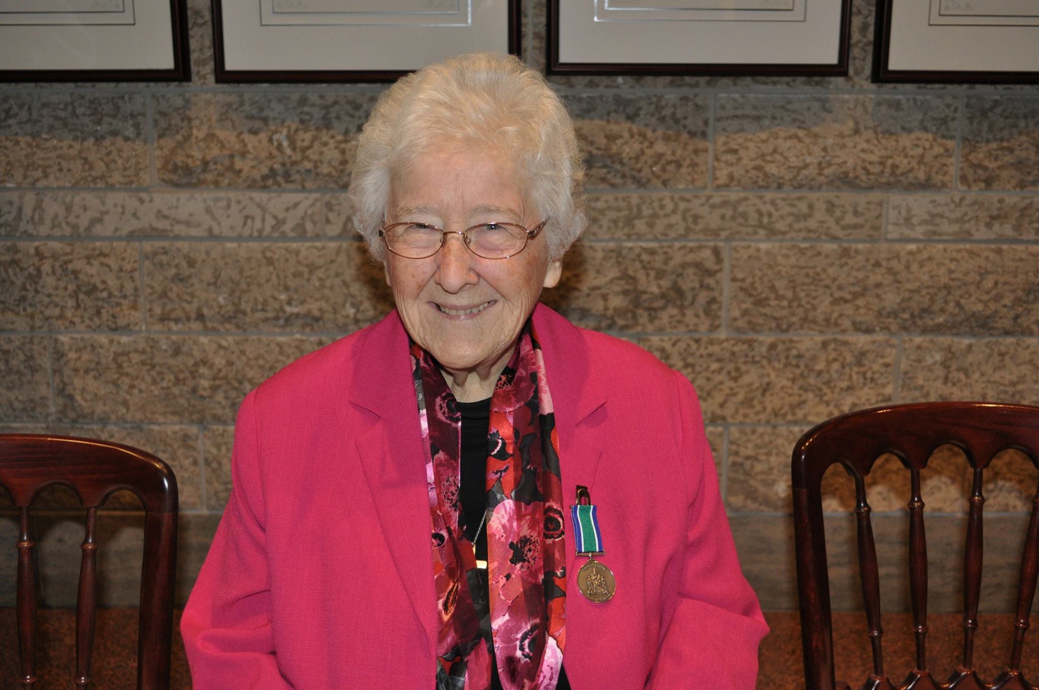 A portrait of co-founder Sister Louise Dunn, CND, smiling warmly.